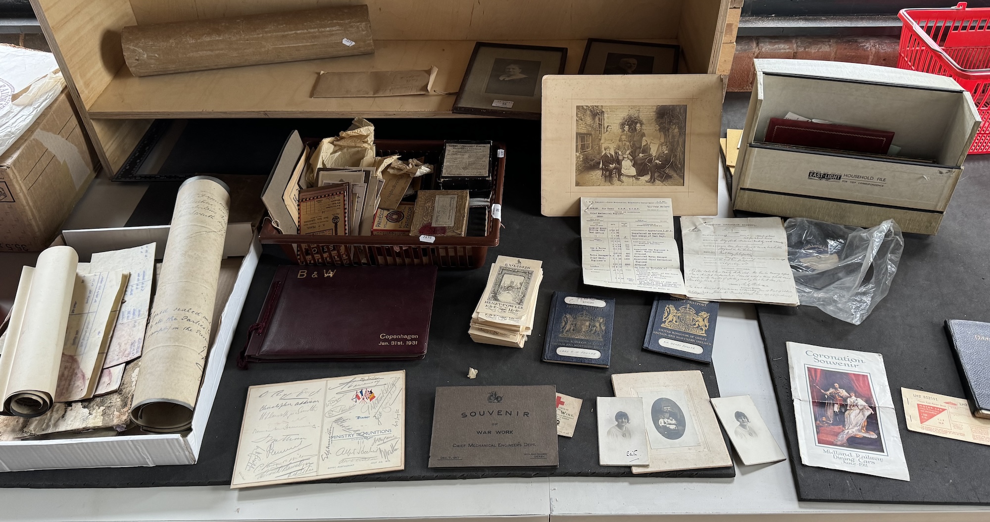 A collection of papers, boxes and ephemera laid out on the Cataloguer's desk in the Midland Railway Study Centre