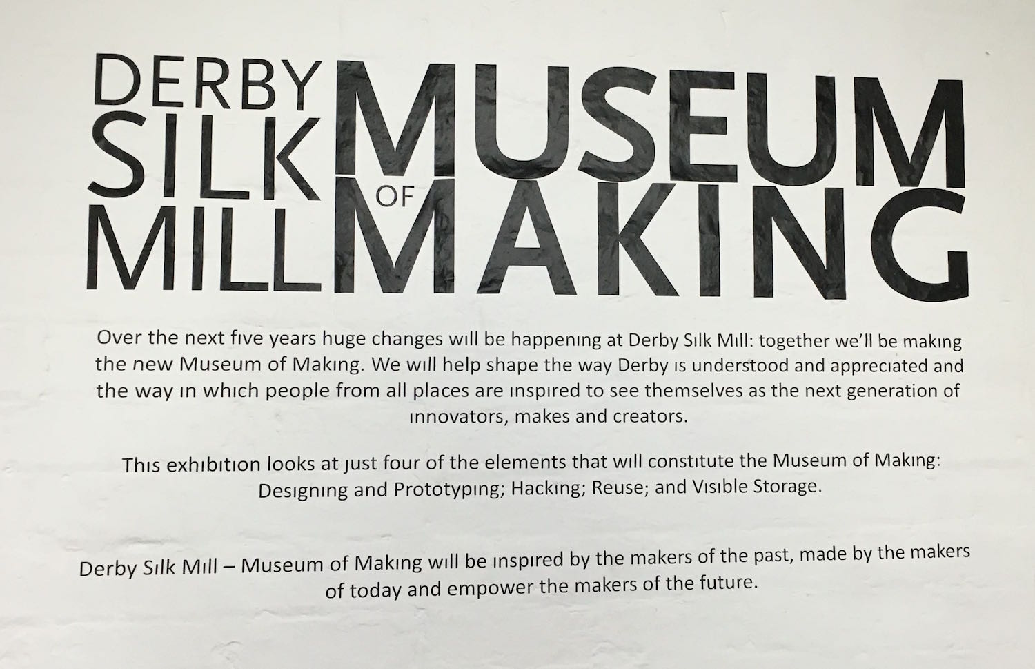 Derby Museum of Making sign on a wall. It reads 'Derby Silk Mill Museum of Making: Over the next five years huge changes will be happening at Derby Silk Mill. Together we’ll be making the new Museum of Making. We will help shape the way Derby is understood and appreciated and the way in which people fro all places are inspired to see themselves as the next generation of innovators, makers and creators.'