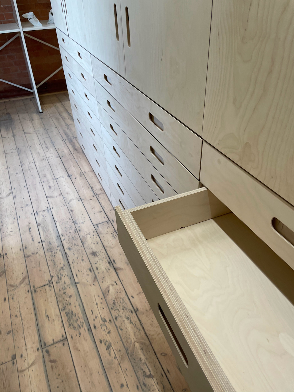 An empty drawer is open within a new plan chest unit