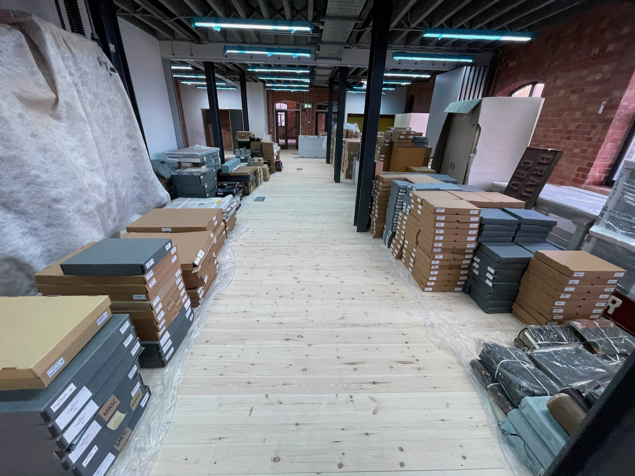 A large space nearly filled with stack and stacks of boxes