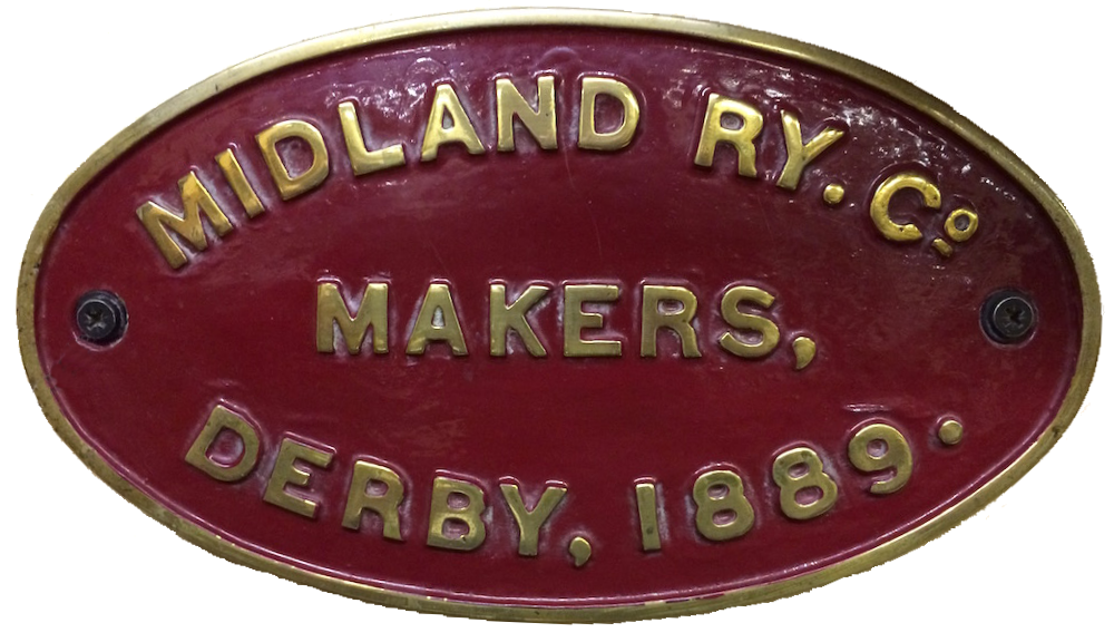 An oval cast brass plaque with maroon background which reads 'Midland Ry Co. - Makers - Derby, 1889.'