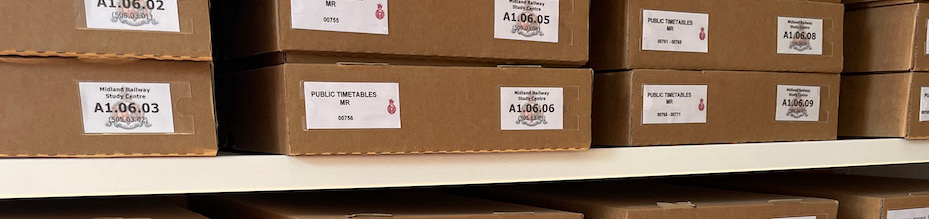 A row of steel racking filled with document storage boxes