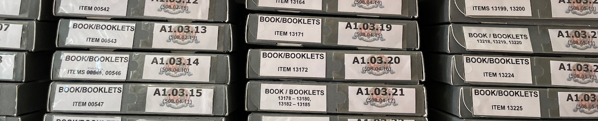 A row of steel racking filled with document storage boxes