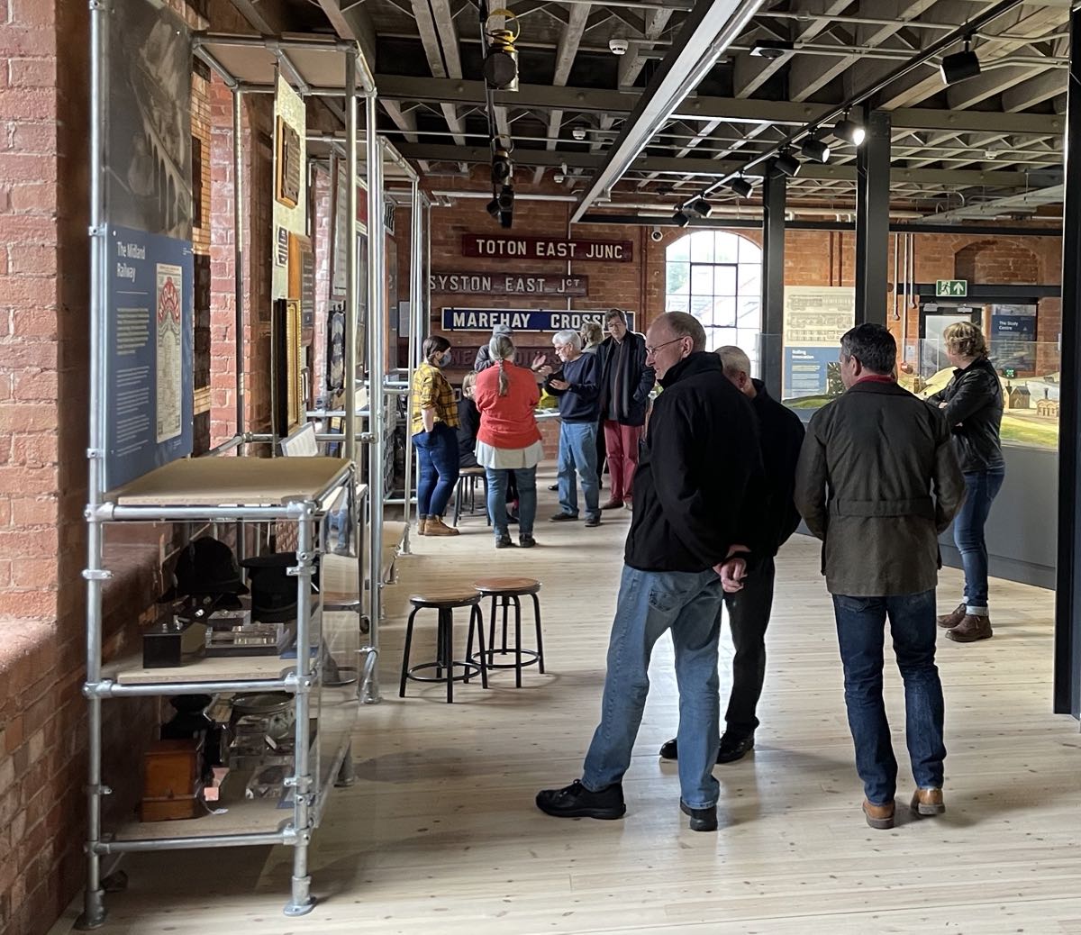 A small gathering of people in the Railways Revealed Gallery of the Museum of Making