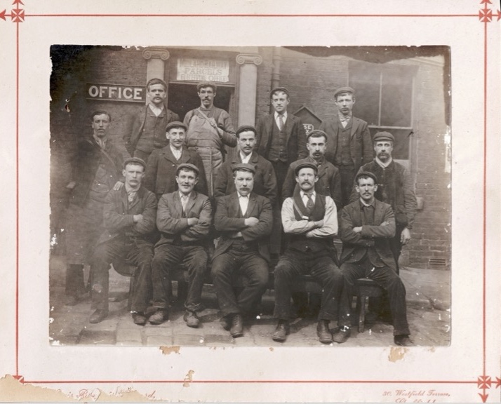 A group of MR employees pose for a local Sheffield photographer in front of a Midland Railway parcels office