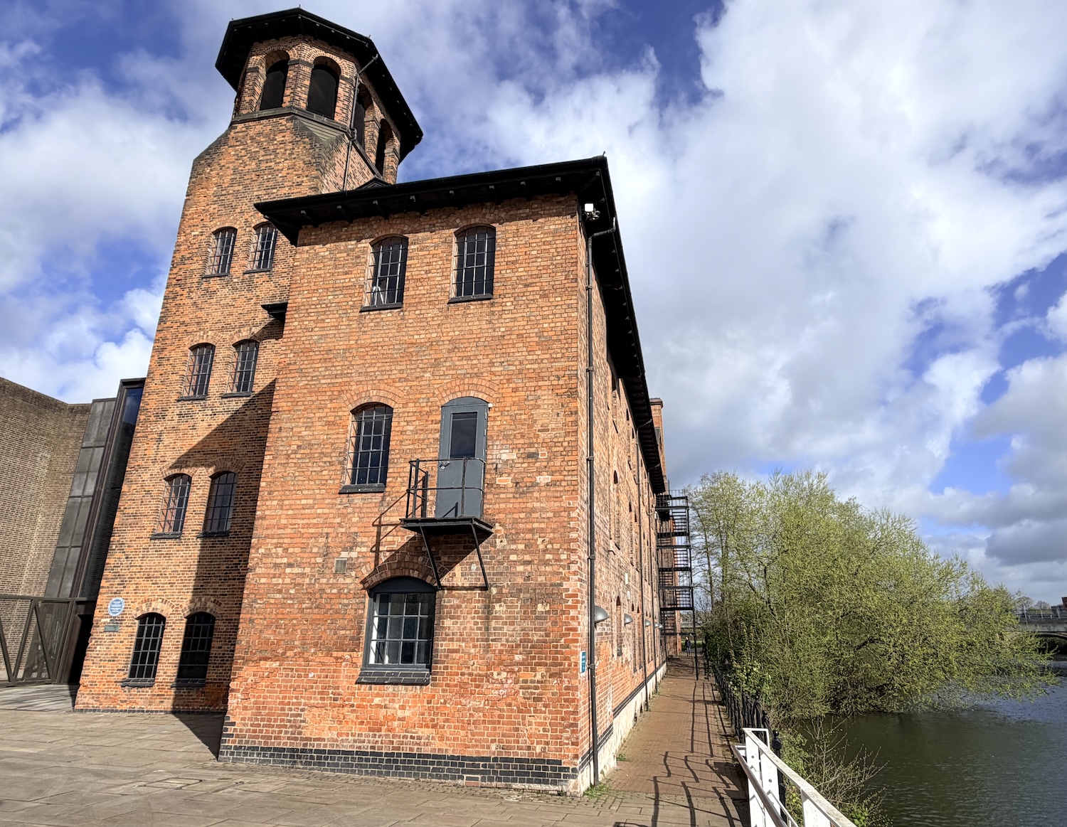 Derby's Silk Mill is seen looking along a very sunny River Derwent.