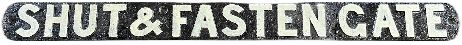 A cast iron sign reading Shut & Fasten Gate -- a typical sight on a Midland Railway line side - our ref. RFB32428