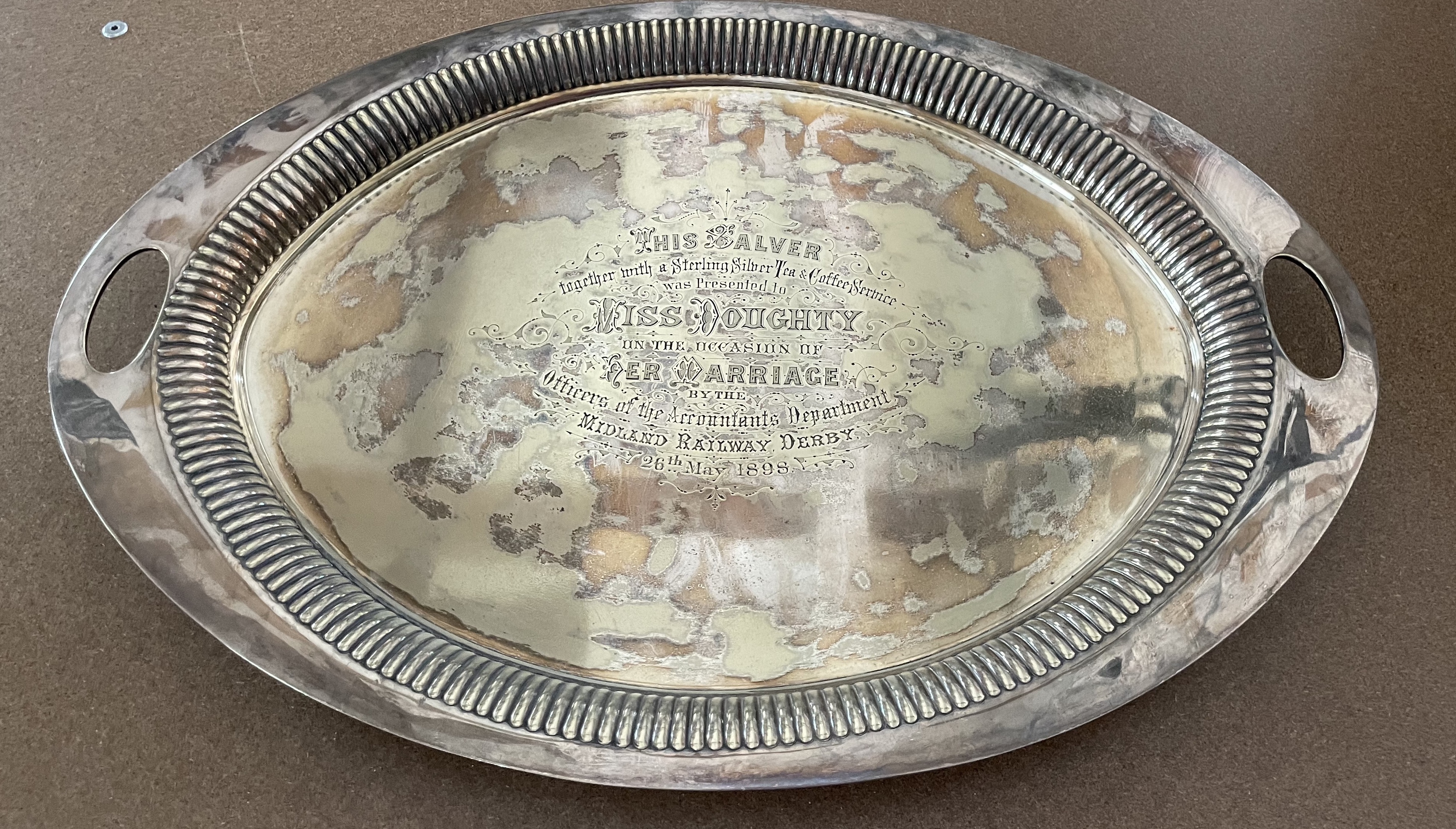 A much closer view of the tray the inscription of which reads; THIS SALVER together with a Sterling Silver Tea & Coffee Service was Presented to MISS DOUGHTY on the occasion of her marriage by the Officers of the Accountants Department of the Midland Railway, Derby. 26th May 1898 