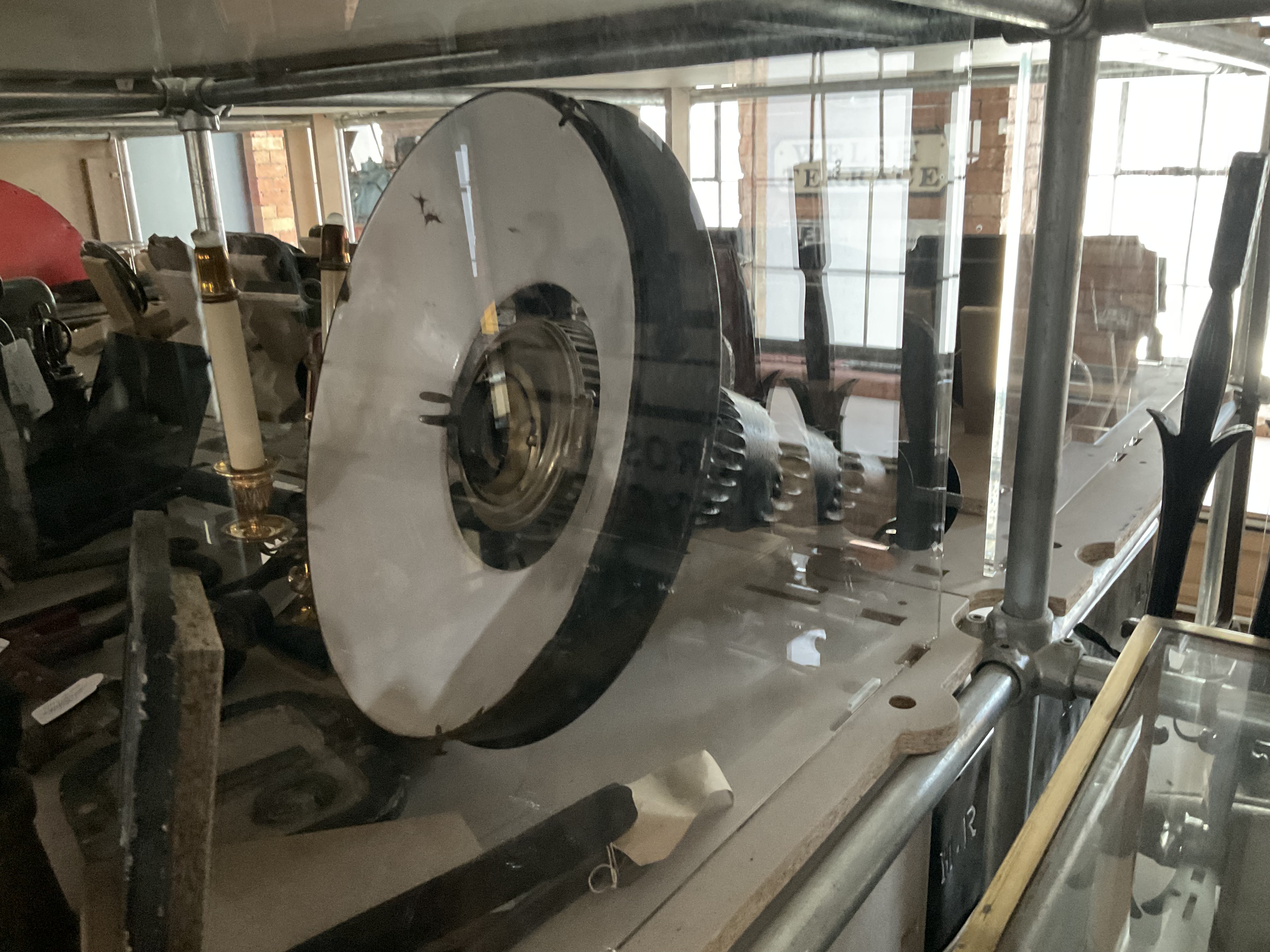 A view of the tall lamp lying on its side in the display cabinet revealing the burner arrangement