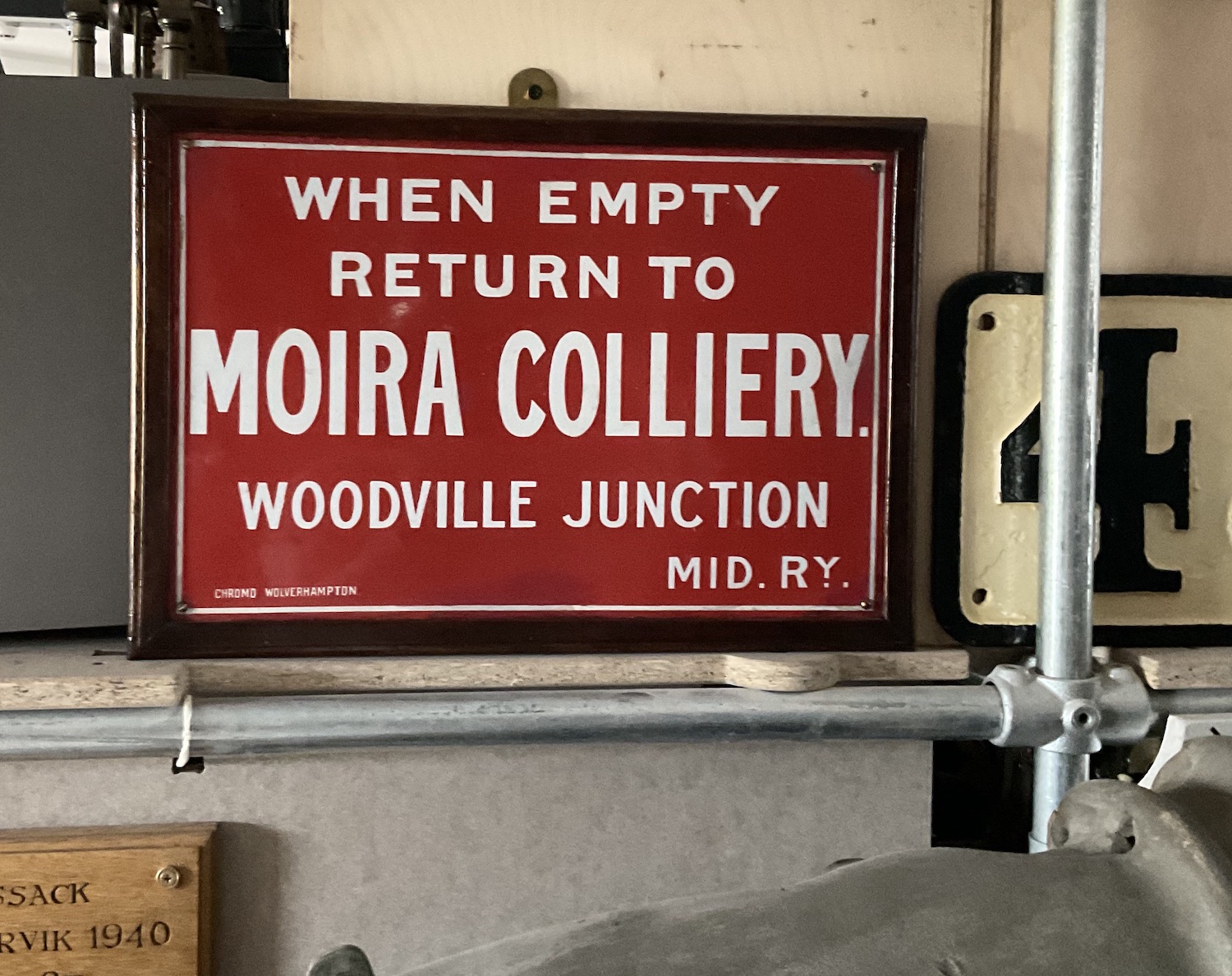 A bright red enamel sign in exceptionally good condition which reads WHEN EMPTY RETURN TO MORA COLLIERY WOODVILLE JUNCTION MID. RY. and in very small letters CHROMO WOLVERHAMPTON