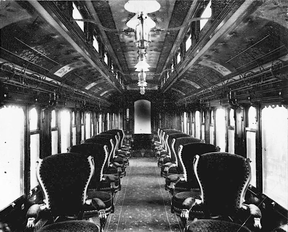 A photogrpah taken inside a Midland Railway Pullman car showing two rows of seats like this alinged with the windows