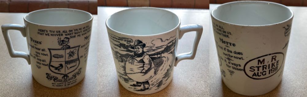 A large ceramic mug bearing a lot of information inclusing a cartoon 'yokel' and the title M.R. Strike 1911.